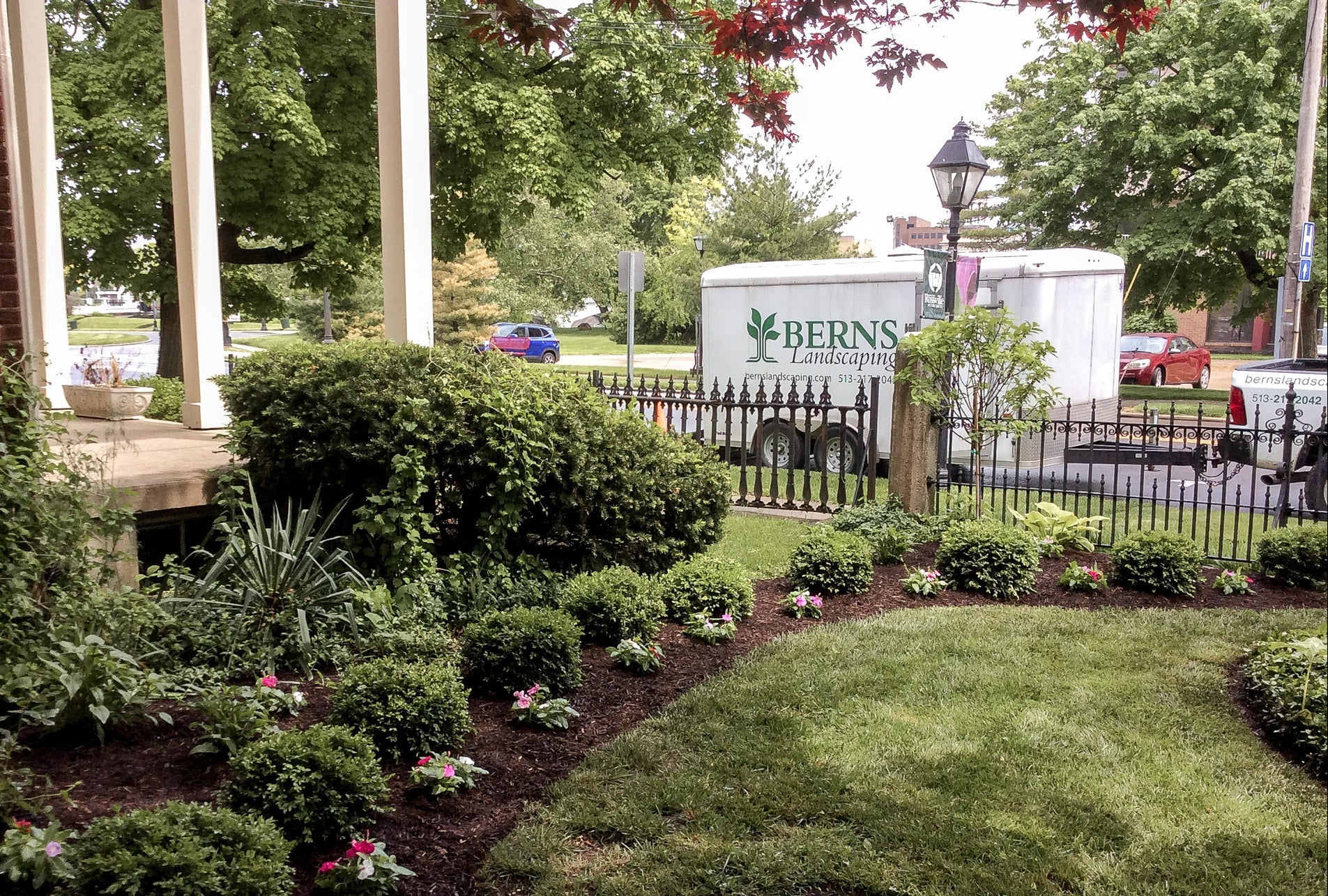 Lawn with landscaping work and a 'Berns Landscaping' truck in the background.