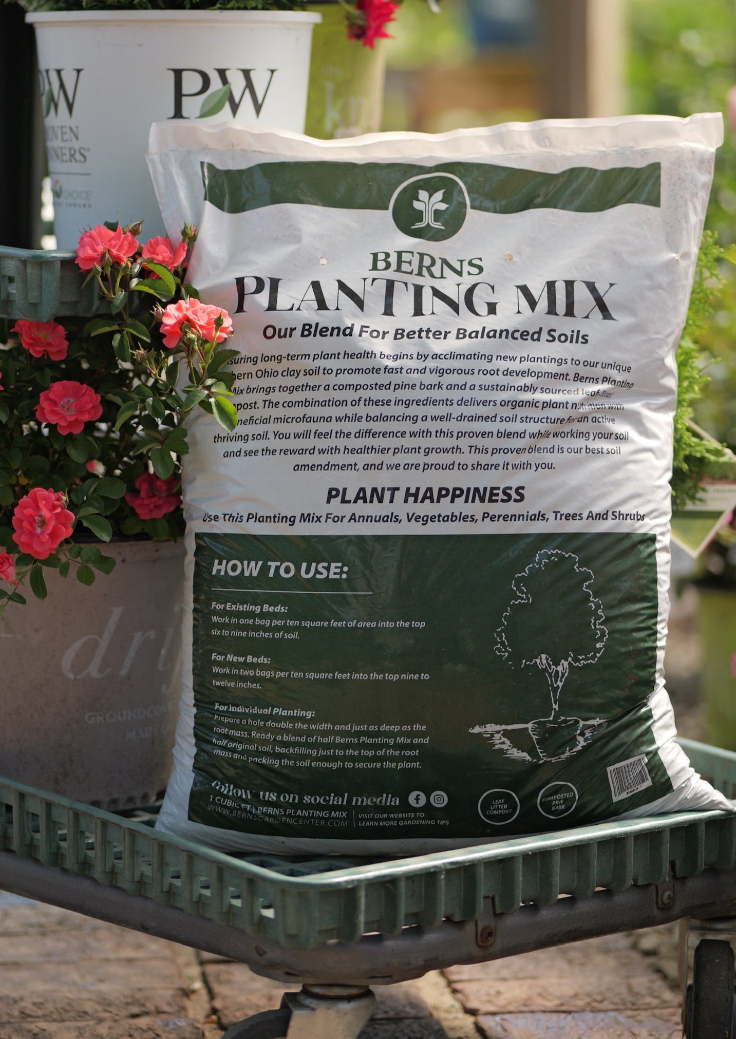 Bag of Berns Planting Mix on a trolley with plants in the background